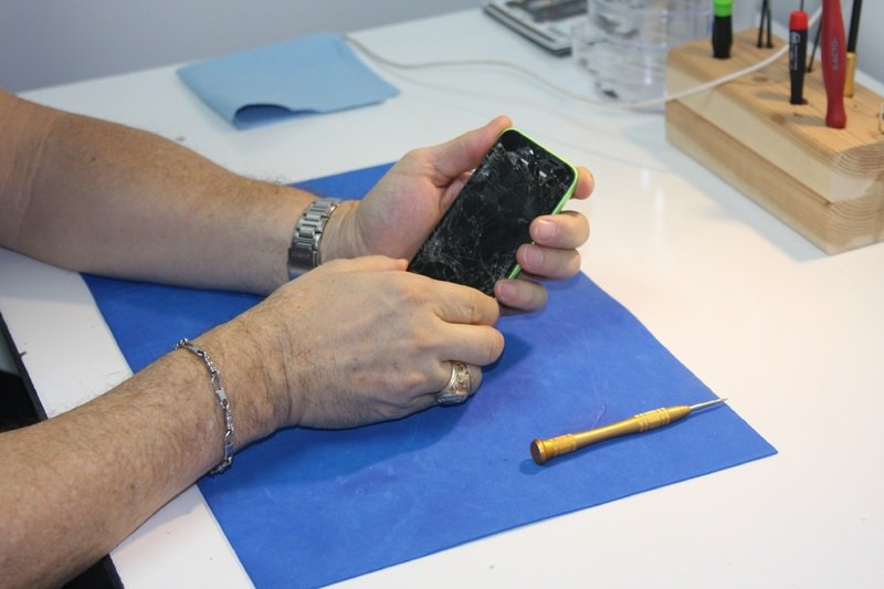 Technician diagnosing phone
